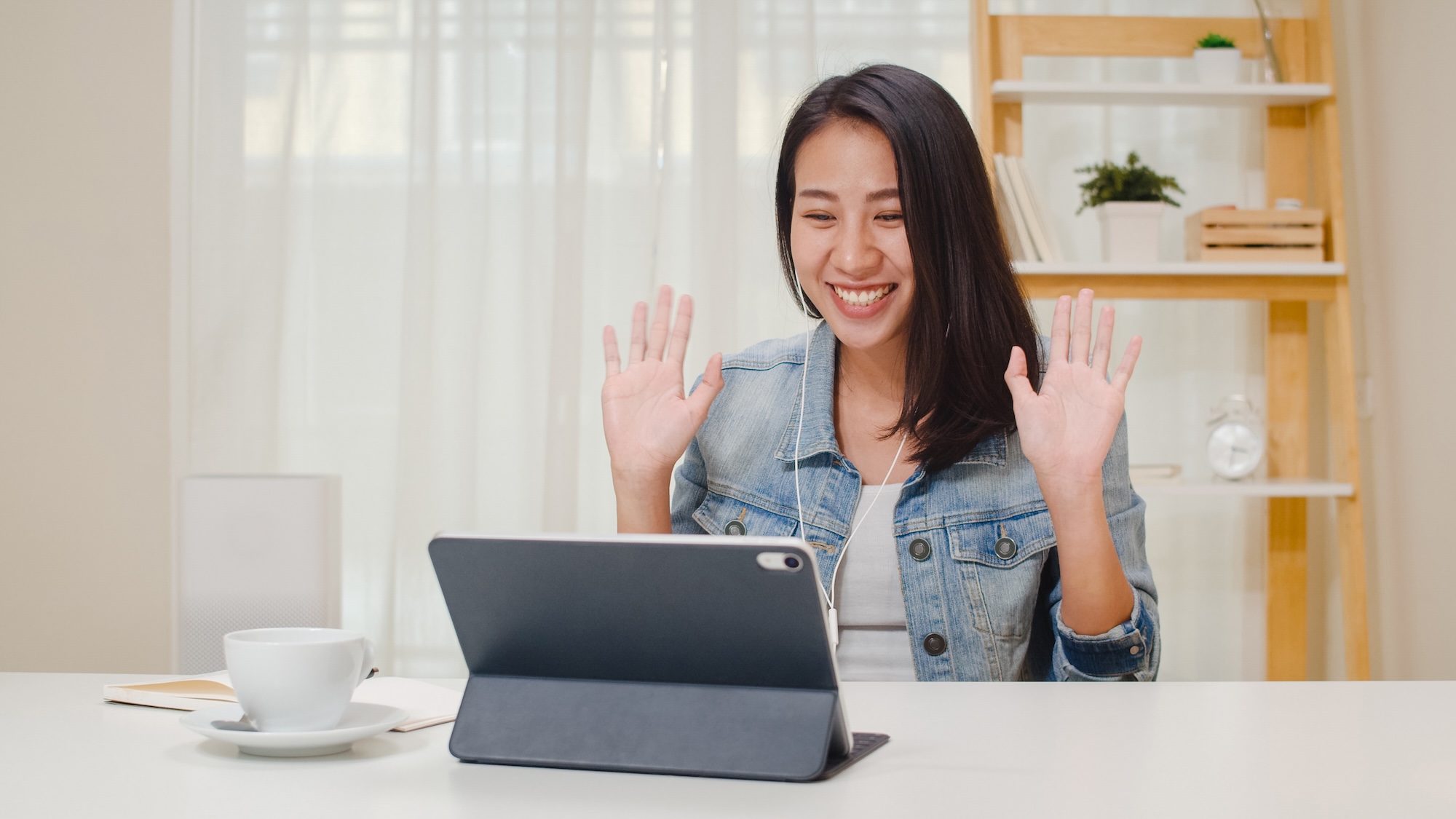 Freelance Business Women Casual Wear Using Tablet Working Call Video Conference With Customer In Workplace In Living Room At Home. Happy Young Asian Girl Relax Sitting On Desk Do Job In Internet.