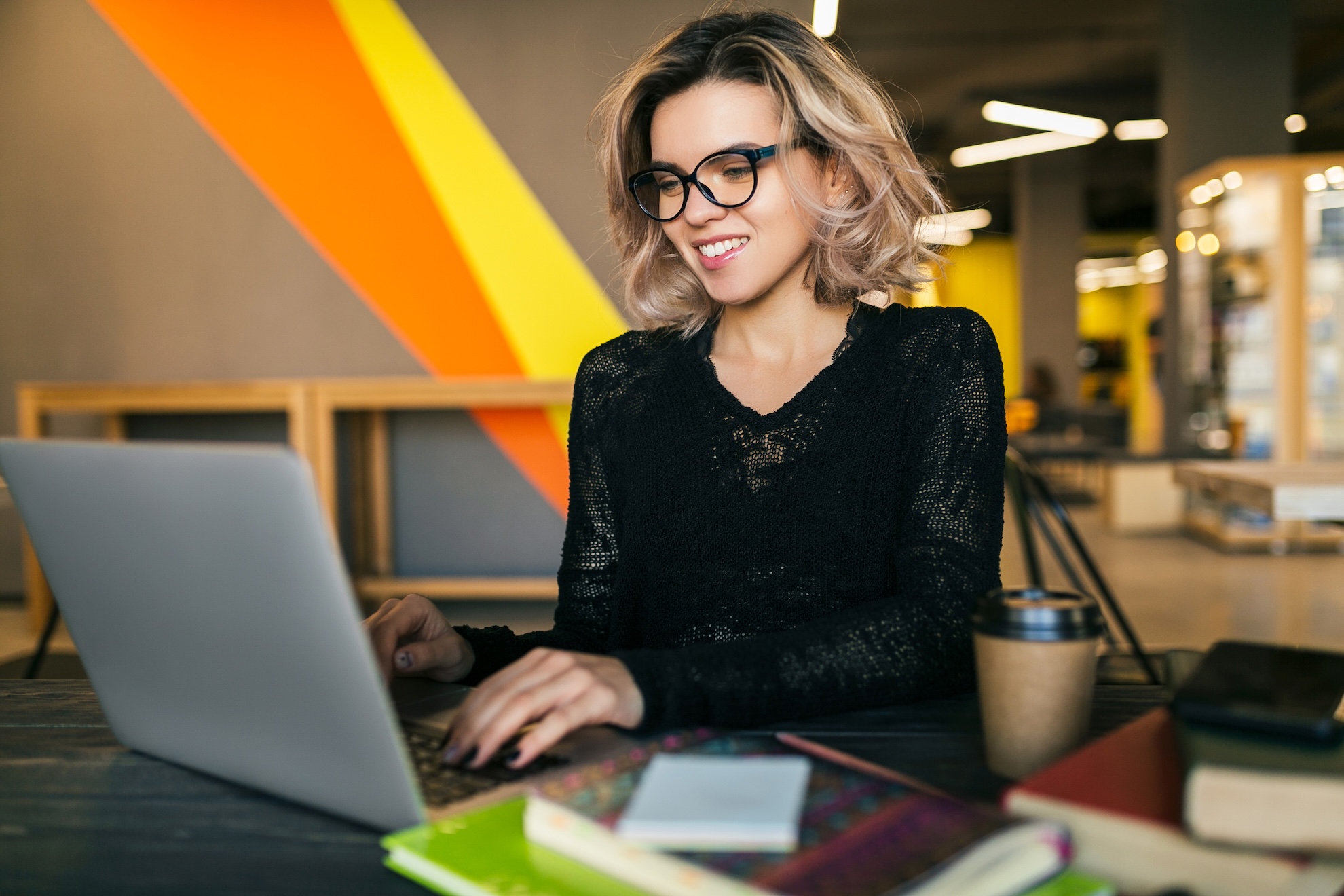 Young Woman Working On Laptop In Co Working Office