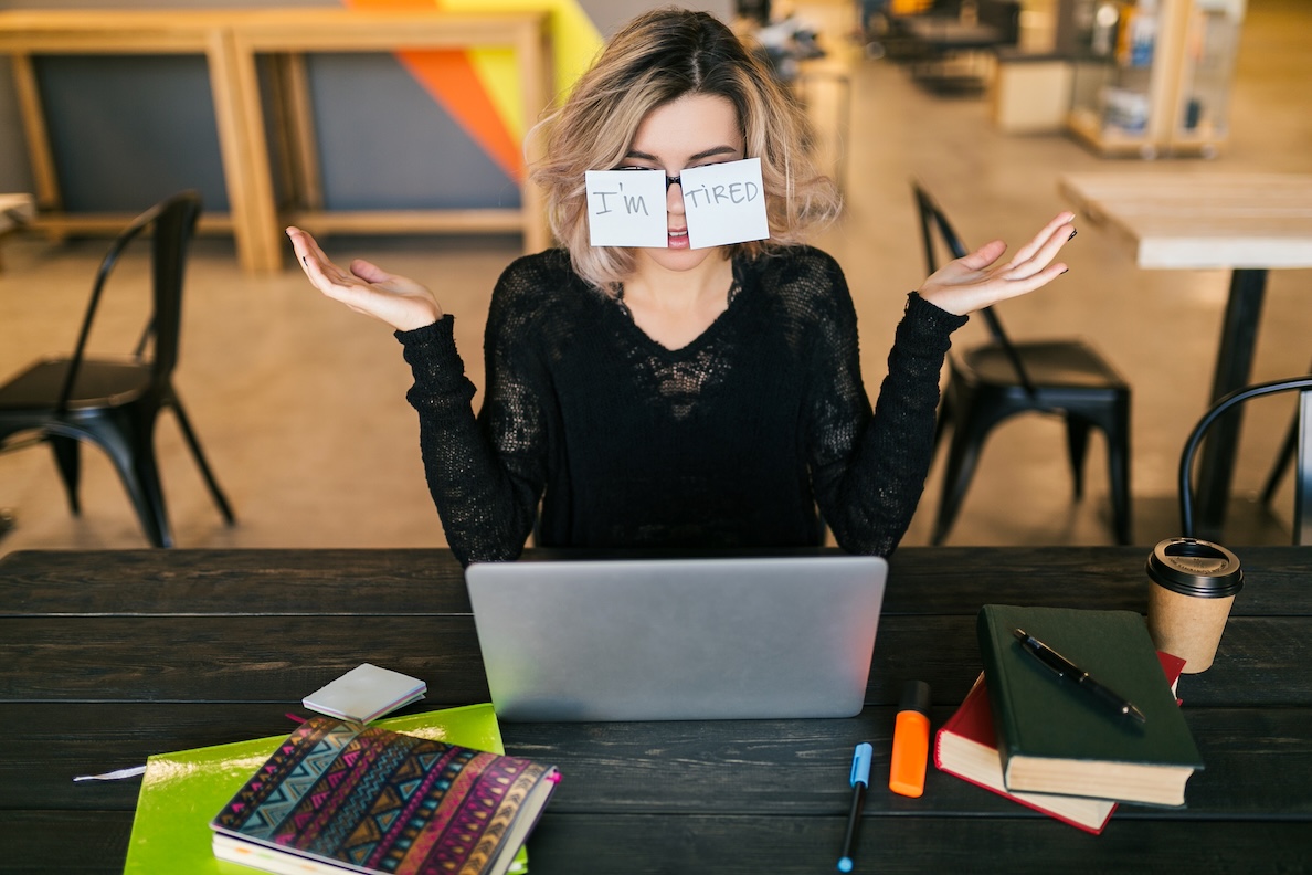 Young Pretty Tired Woman With Paper Stickers On Glasses Sitting At Table In Black Shirt Working On Laptop In Co Working Office, Funny Face Emotion, Problem, Workplace, Holding Hands Up